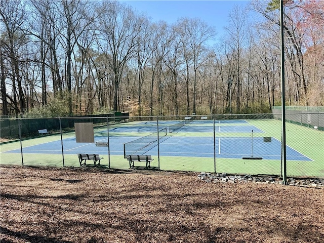 view of sport court featuring fence