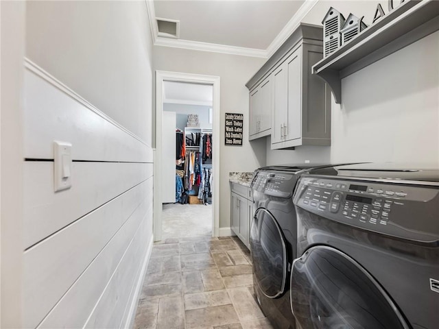 laundry area featuring cabinets, crown molding, and independent washer and dryer