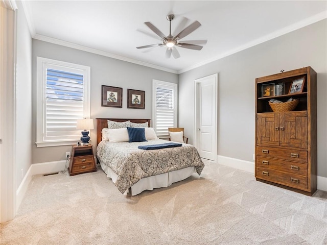 bedroom featuring crown molding, light colored carpet, and ceiling fan