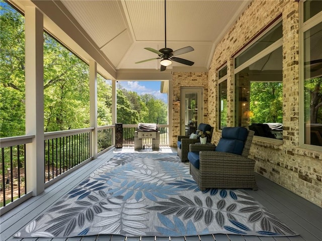 wooden deck with area for grilling and ceiling fan