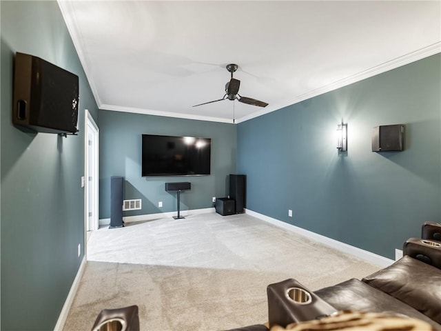 carpeted cinema room featuring ceiling fan and ornamental molding