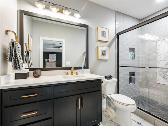 bathroom featuring vanity, an enclosed shower, and toilet