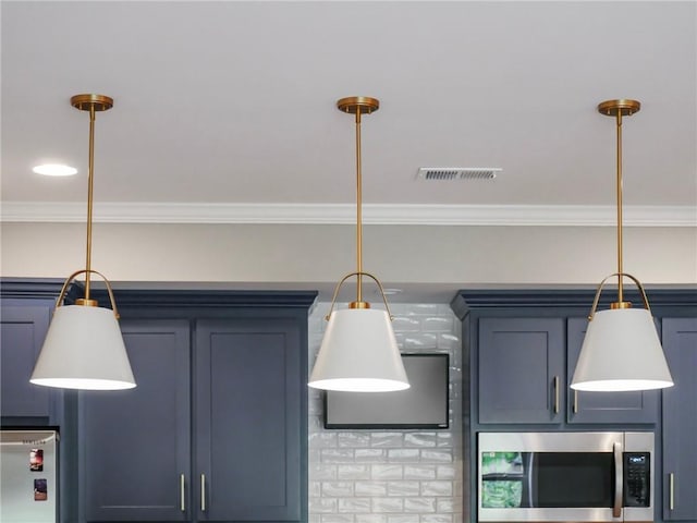 interior details with crown molding, fridge, blue cabinets, and hanging light fixtures