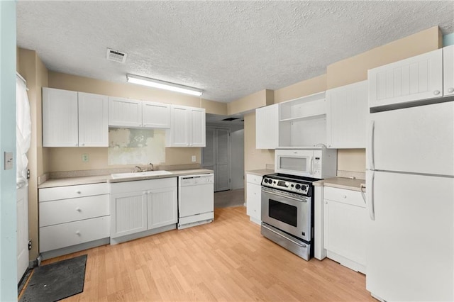 185 Lee Path, Acworth, GA 30102 - kitchen with white appliances, open shelves, light wood-type flooring, a textured ceiling, and white cabinets
