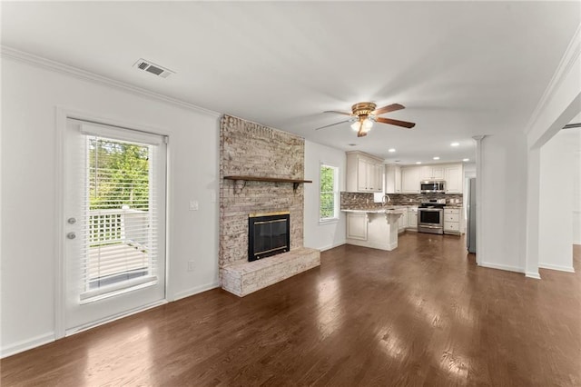 185 Lee Path, Acworth, GA 30102 - unfurnished living room featuring ceiling fan, dark wood-style floors, crown molding, a fireplace, and recessed lighting