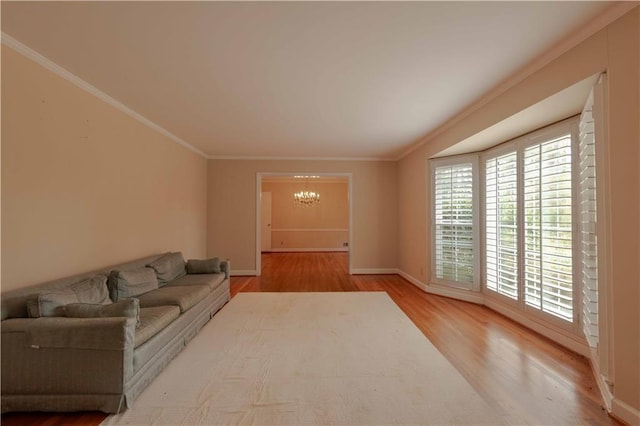 living room with ornamental molding, light hardwood / wood-style flooring, and a notable chandelier