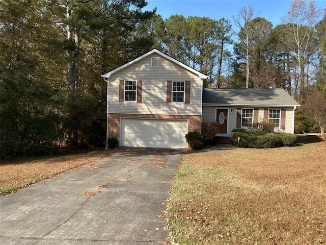 split level home featuring a front lawn and a garage