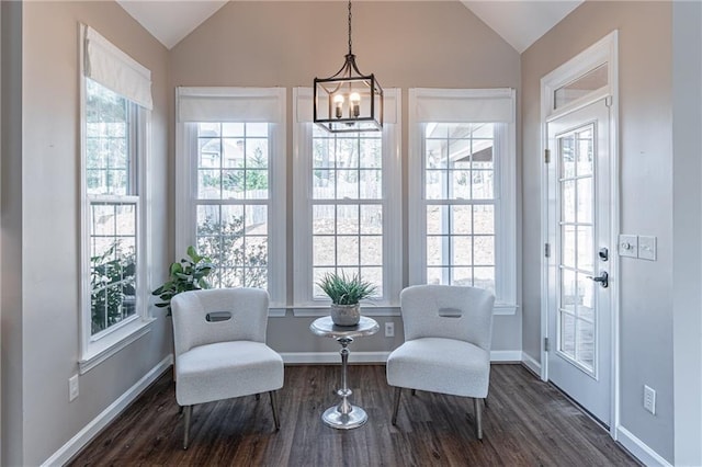 sitting room featuring vaulted ceiling, dark hardwood / wood-style floors, and an inviting chandelier