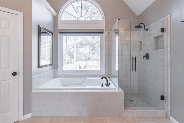 bathroom featuring tile patterned floors, lofted ceiling, shower with separate bathtub, and a wealth of natural light