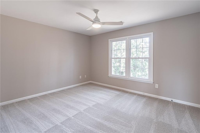 unfurnished room featuring ceiling fan and carpet