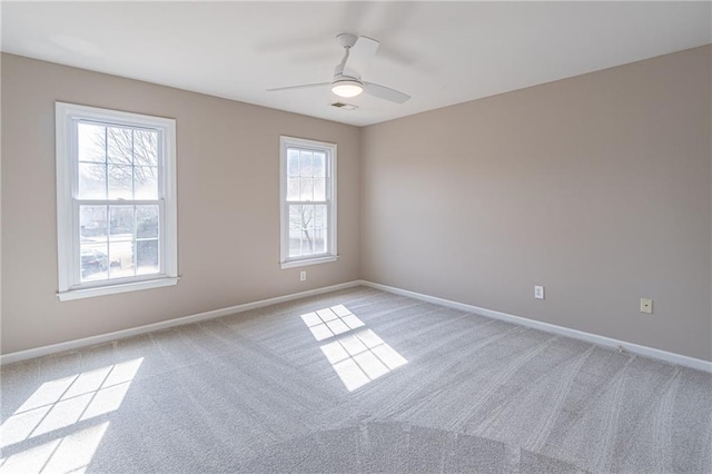 spare room featuring ceiling fan and light colored carpet