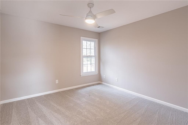 empty room featuring carpet floors and ceiling fan