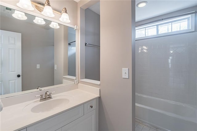 bathroom with vanity and tiled shower / bath combo