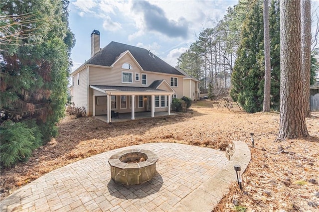 back of house with a patio area and a fire pit