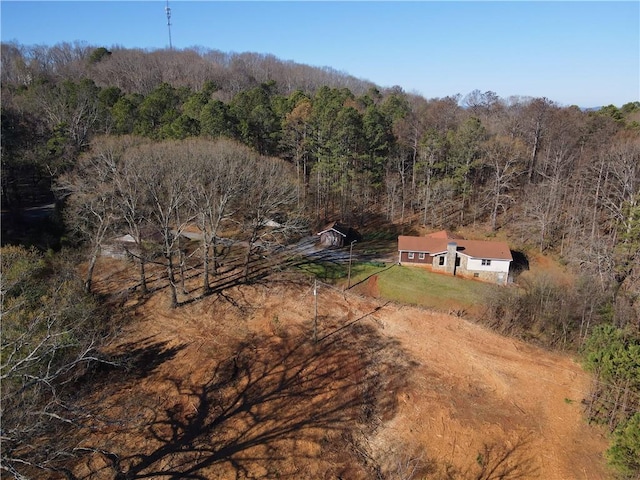 birds eye view of property featuring a view of trees