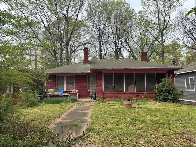 349 Hopkins St SW, Atlanta, GA 30310 - view of front of house with a sunroom, brick siding, a front yard, and a chimney