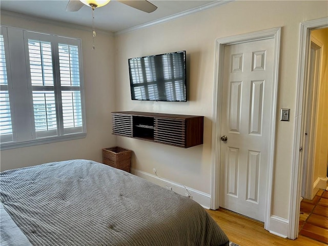 1078 Piedmont Ave NE Unit 206, Atlanta, GA 30309 - bedroom with ornamental molding, light wood-type flooring, baseboards, and ceiling fan