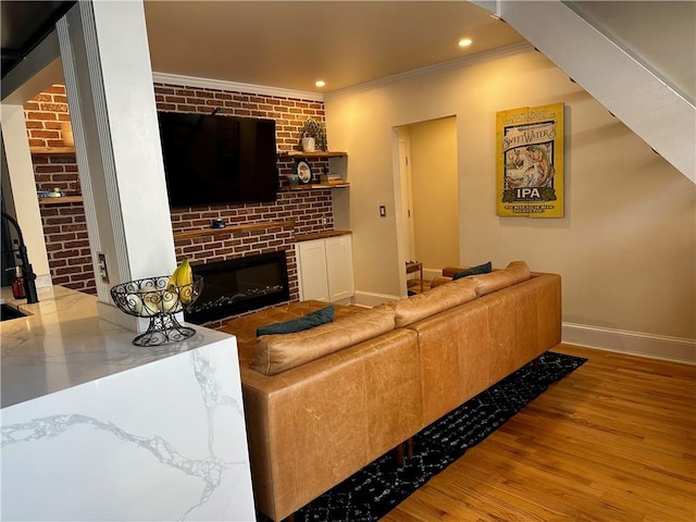 1078 Piedmont Ave NE Unit 206, Atlanta, GA 30309 - living room with ornamental molding, a brick fireplace, baseboards, wood finished floors, and recessed lighting