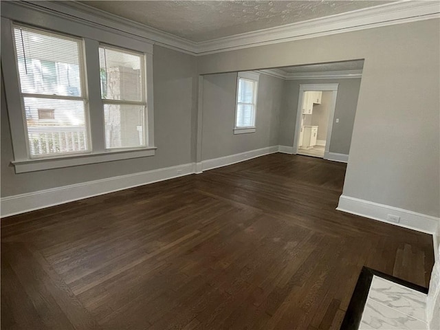 spare room featuring a wealth of natural light, crown molding, dark hardwood / wood-style floors, and a textured ceiling