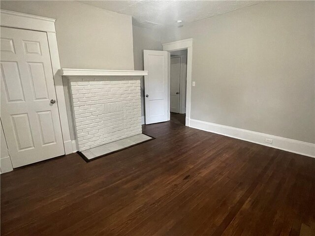 unfurnished living room featuring dark wood-type flooring