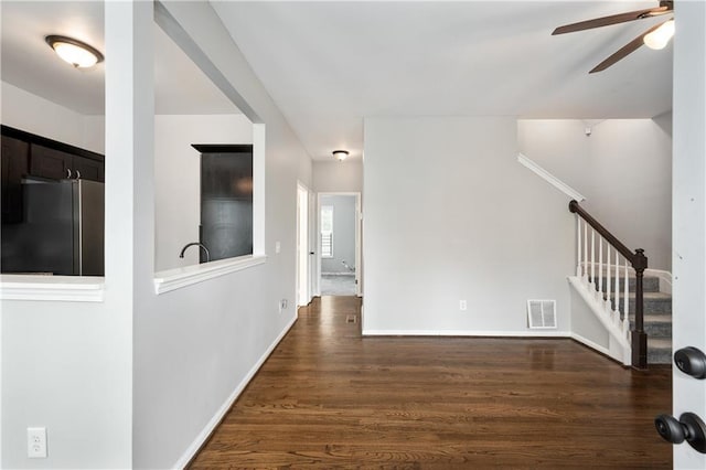 interior space with ceiling fan and dark hardwood / wood-style flooring