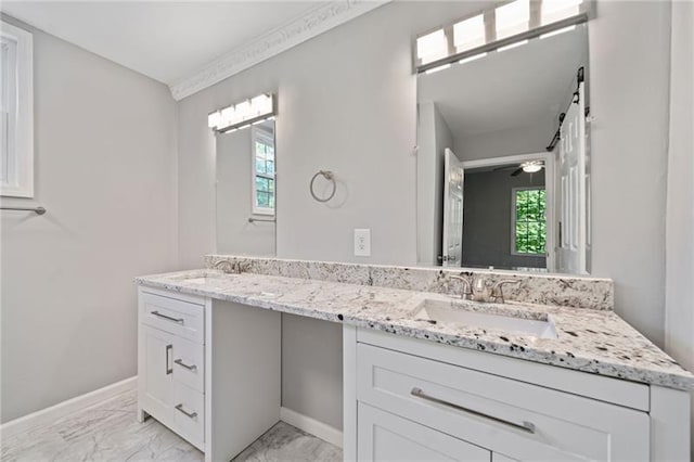 bathroom with ceiling fan, vanity, a healthy amount of sunlight, and ornamental molding