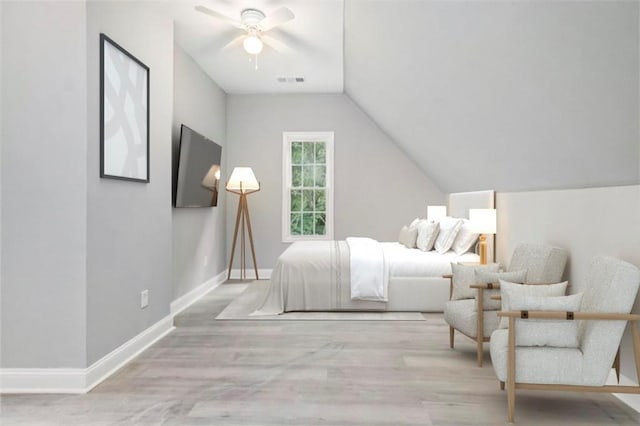 bedroom with ceiling fan, vaulted ceiling, and light hardwood / wood-style flooring