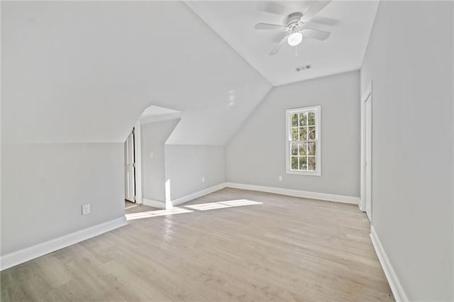 additional living space with lofted ceiling, light wood-type flooring, and ceiling fan