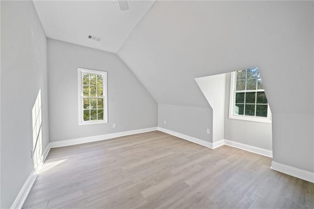 bonus room featuring lofted ceiling and light hardwood / wood-style flooring