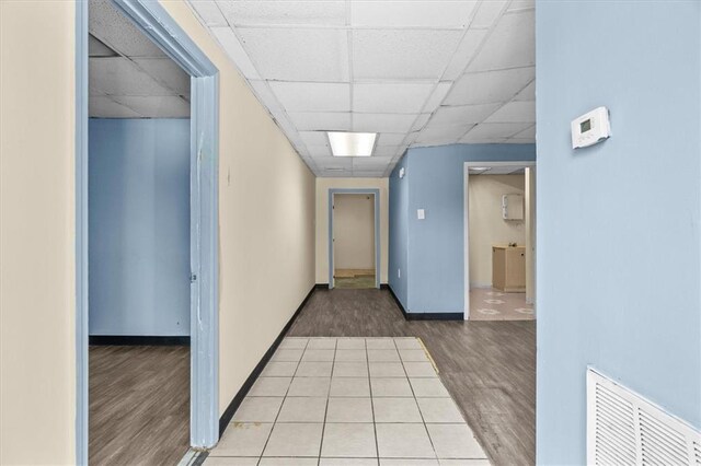 843 Mcafee St, Dalton, GA 30721 - hallway with wood finished floors, visible vents, and a paneled ceiling
