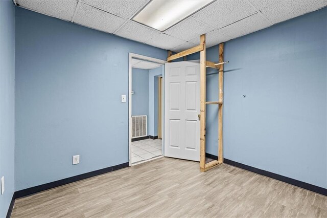 843 Mcafee St, Dalton, GA 30721 - spare room with a drop ceiling, wood finished floors, visible vents, and baseboards