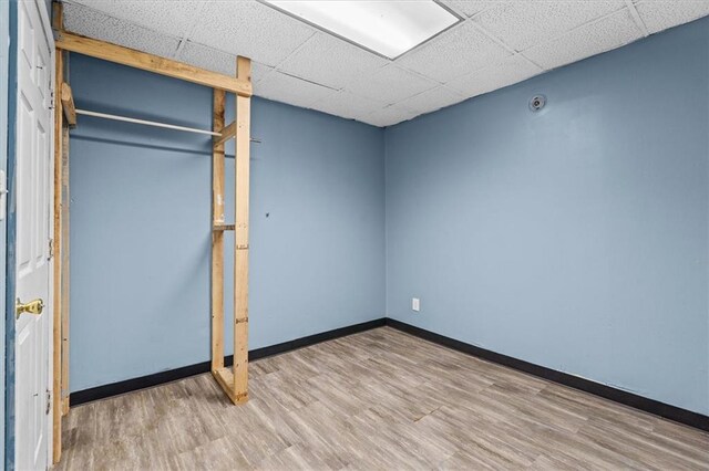 843 Mcafee St, Dalton, GA 30721 - unfurnished bedroom featuring baseboards, wood finished floors, and a drop ceiling