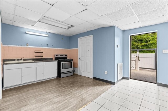 843 Mcafee St, Dalton, GA 30721 - kitchen featuring white cabinets, a drop ceiling, visible vents, a sink, and stainless steel range with electric stovetop