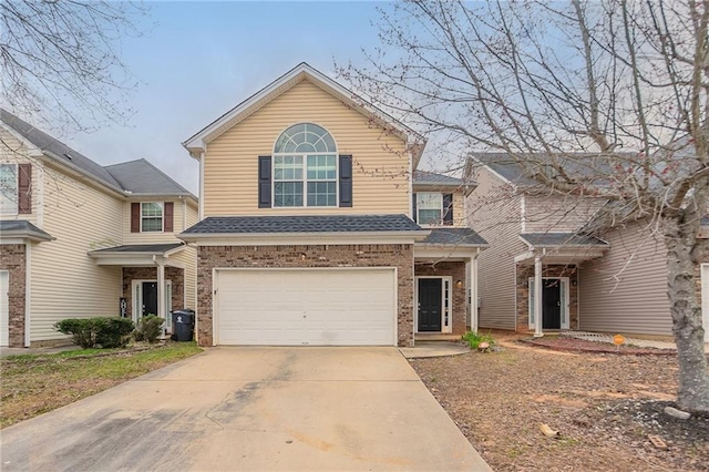 11143 Aliyah Dr, Hampton, GA 30228 - traditional-style home with concrete driveway, an attached garage, brick siding, and roof with shingles