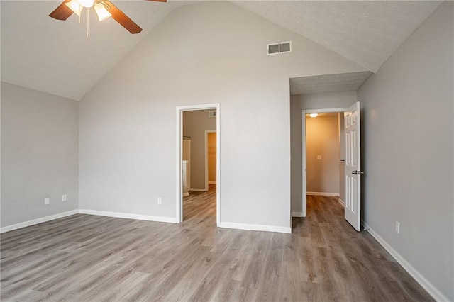 11143 Aliyah Dr, Hampton, GA 30228 - unfurnished bedroom with a ceiling fan, wood finished floors, visible vents, high vaulted ceiling, and baseboards