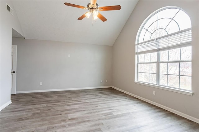 11143 Aliyah Dr, Hampton, GA 30228 - spare room with visible vents, wood finished floors, a ceiling fan, and vaulted ceiling