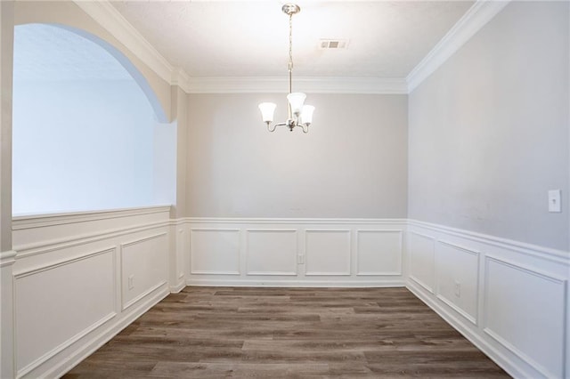 11143 Aliyah Dr, Hampton, GA 30228 - unfurnished dining area with visible vents, arched walkways, dark wood-type flooring, and an inviting chandelier