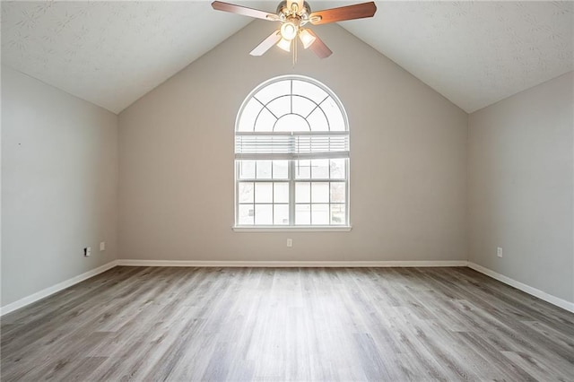 11143 Aliyah Dr, Hampton, GA 30228 - unfurnished room featuring wood finished floors, baseboards, ceiling fan, vaulted ceiling, and a textured ceiling