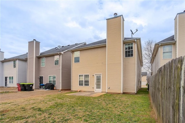 11143 Aliyah Dr, Hampton, GA 30228 - back of house with a patio area, a lawn, fence, and a chimney