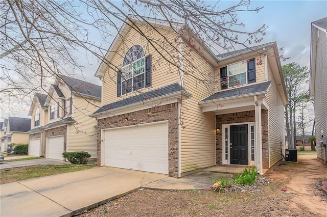 11143 Aliyah Dr, Hampton, GA 30228 - traditional-style house featuring brick siding, an attached garage, driveway, and central AC