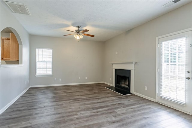 11143 Aliyah Dr, Hampton, GA 30228 - unfurnished living room with visible vents, a ceiling fan, and wood finished floors
