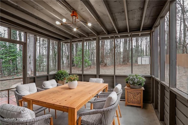 sunroom / solarium with a chandelier