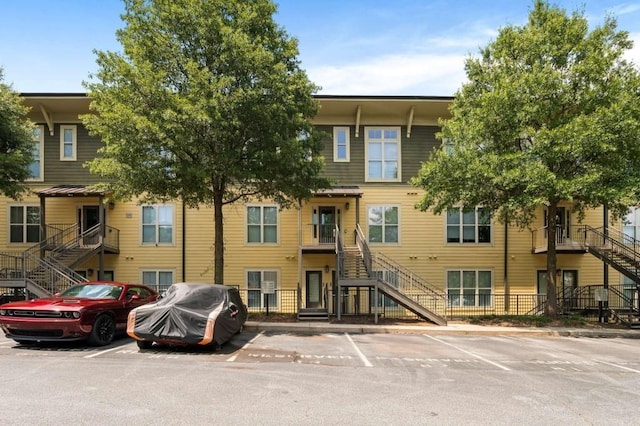 1195 Milton Ter SE Unit 1407, Atlanta, GA 30315 - view of property featuring stairway and uncovered parking
