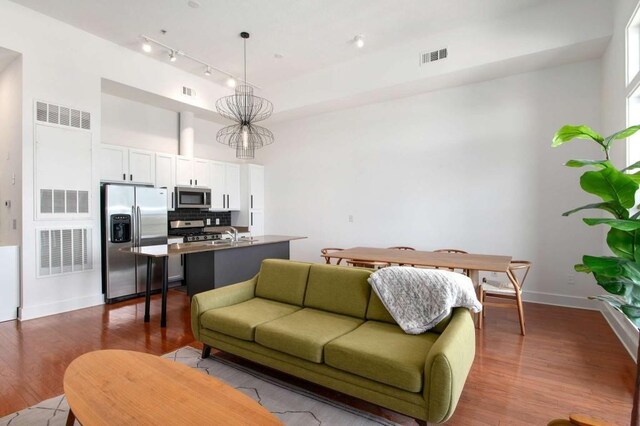 1195 Milton Ter SE Unit 1407, Atlanta, GA 30315 - living area featuring dark wood finished floors, baseboards, and a high ceiling