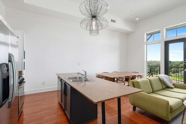 1195 Milton Ter SE Unit 1407, Atlanta, GA 30315 - kitchen featuring a sink, a chandelier, appliances with stainless steel finishes, dark wood-type flooring, and baseboards