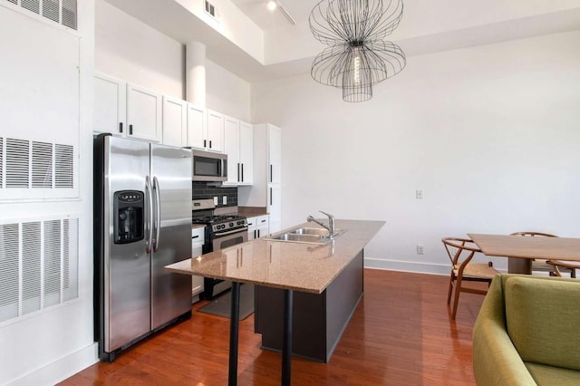 1195 Milton Ter SE Unit 1407, Atlanta, GA 30315 - kitchen featuring stainless steel appliances, a sink, baseboards, dark wood-style flooring, and a high ceiling