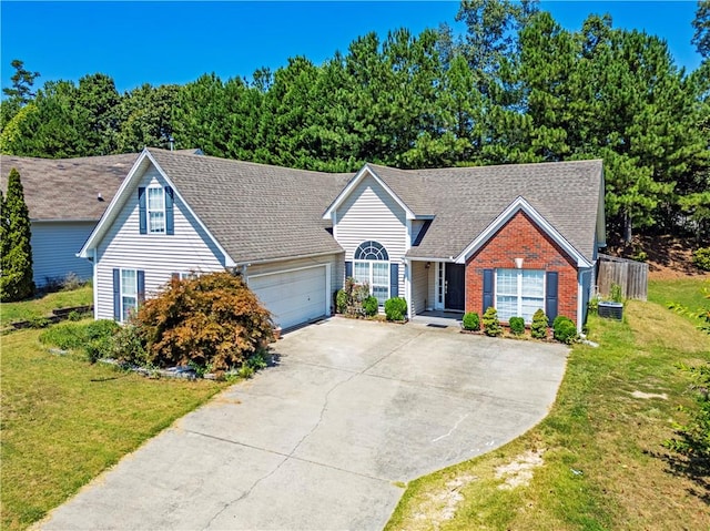 view of front of home with a front yard and a garage