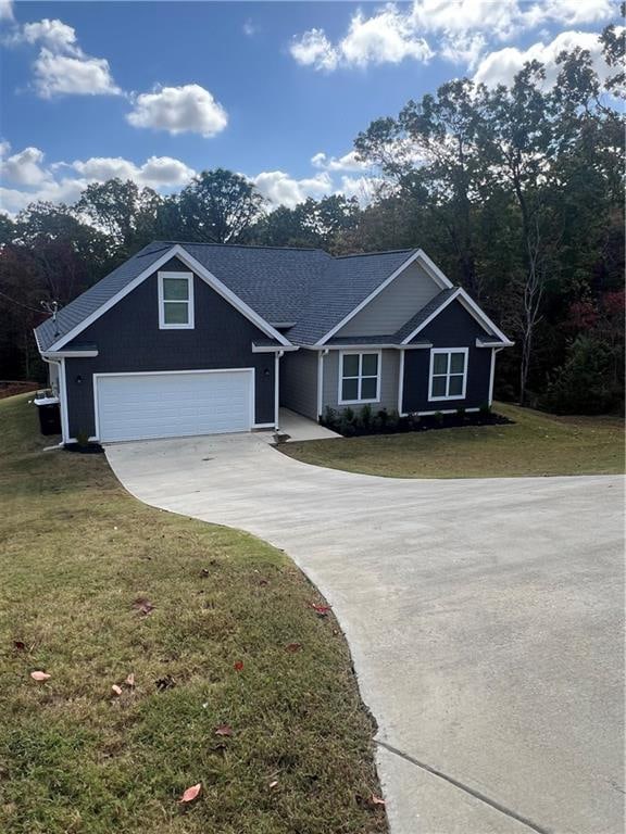 ranch-style home with a front lawn and a garage