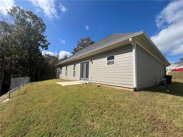 back of property featuring a lawn