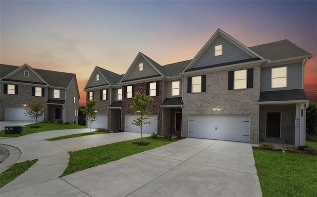 view of front of house featuring a garage and a lawn